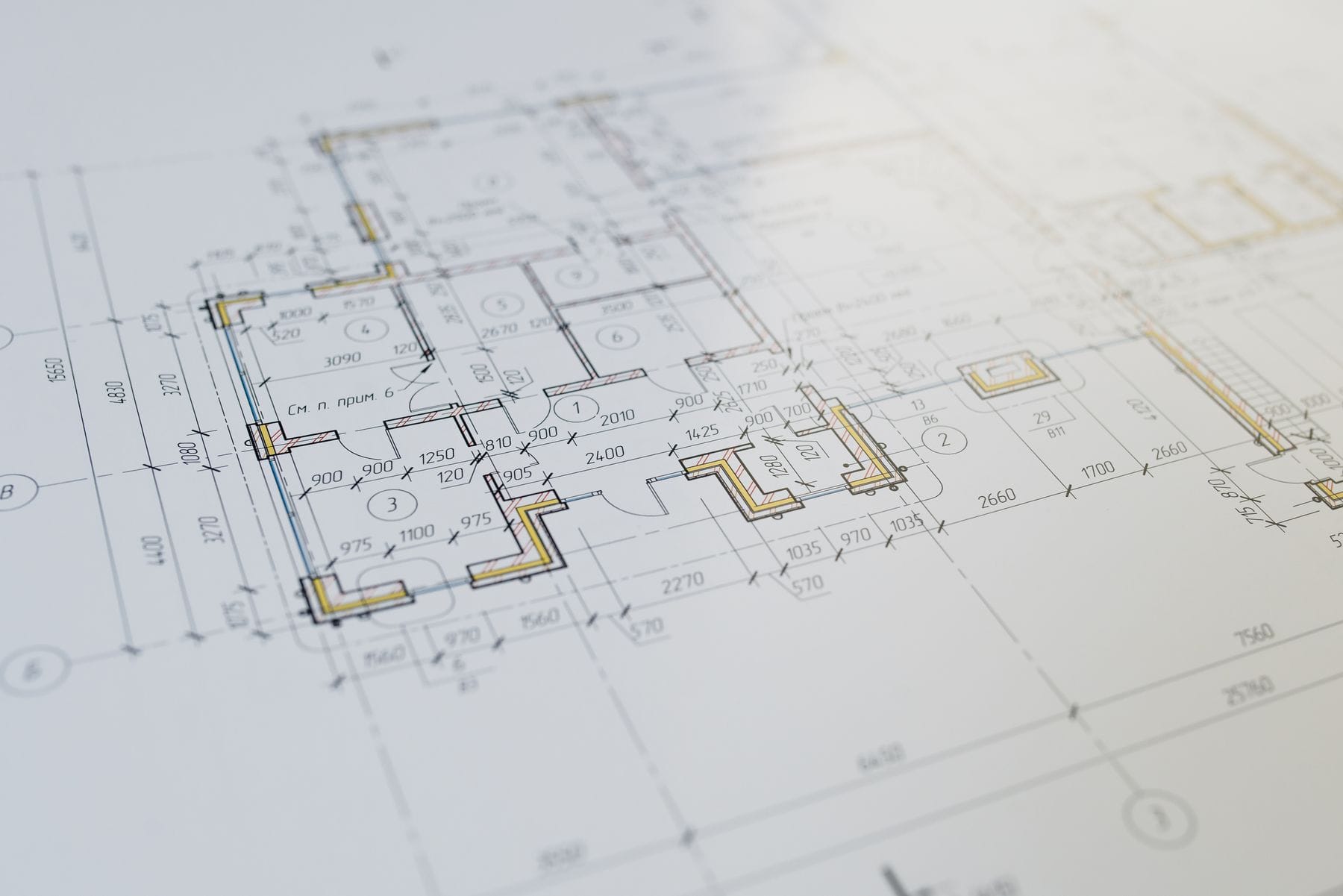 Architectural floor-plan drawings on a desk